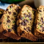 Close-up of chocolate chip zucchini bread with melty chips and golden crust